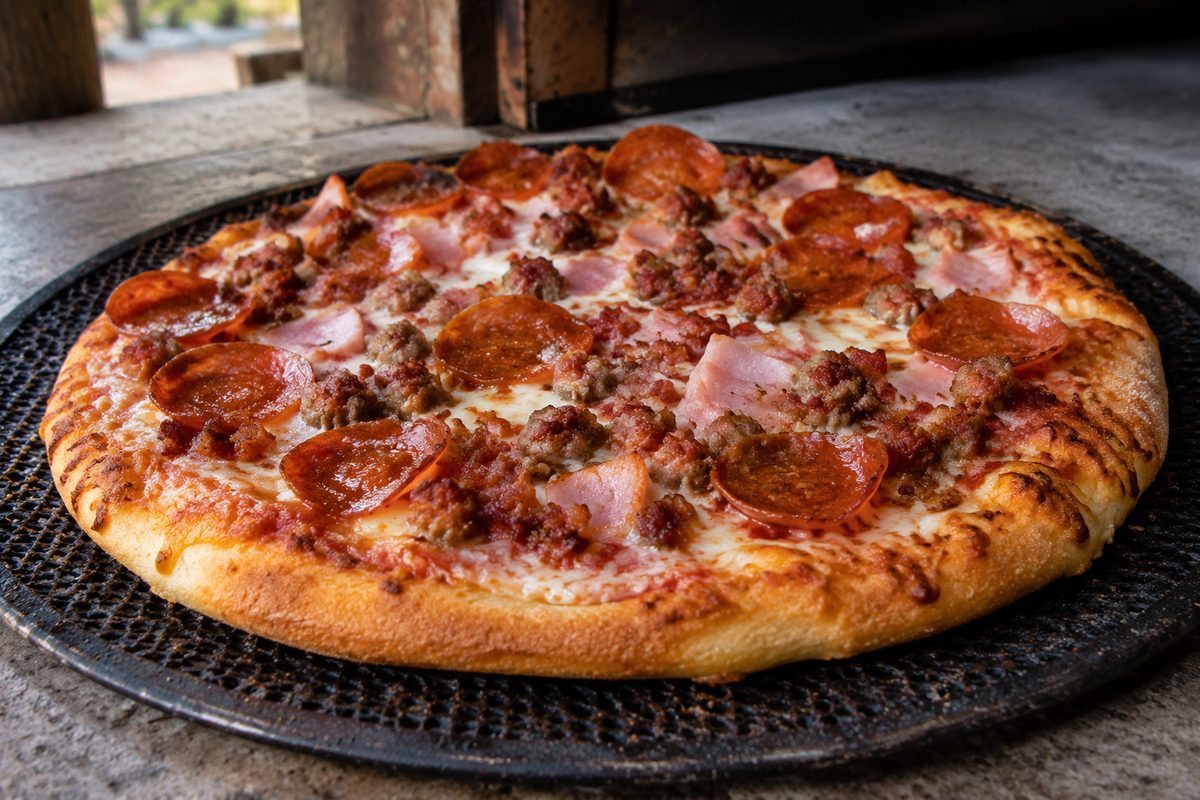 Meat specialty pizza loaded with bacon, ham, sausage, and pepperoni